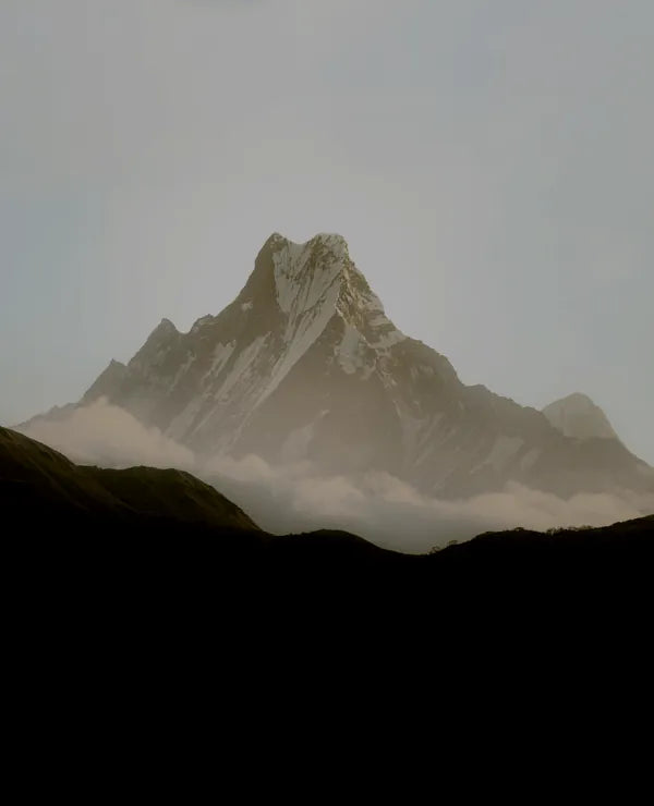 Mountain peak rising above the clouds