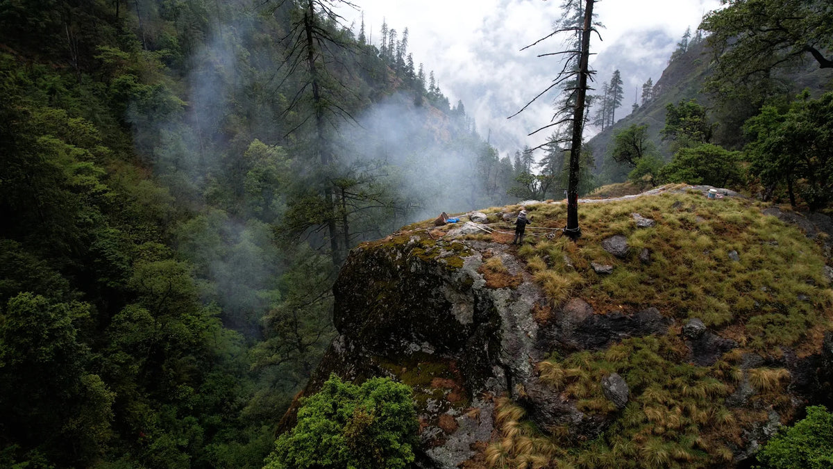 Aerial view of the remote far-west Nepal cliffs where wild mad honey is harvested, sheer rock faces dropping into a deep river valley