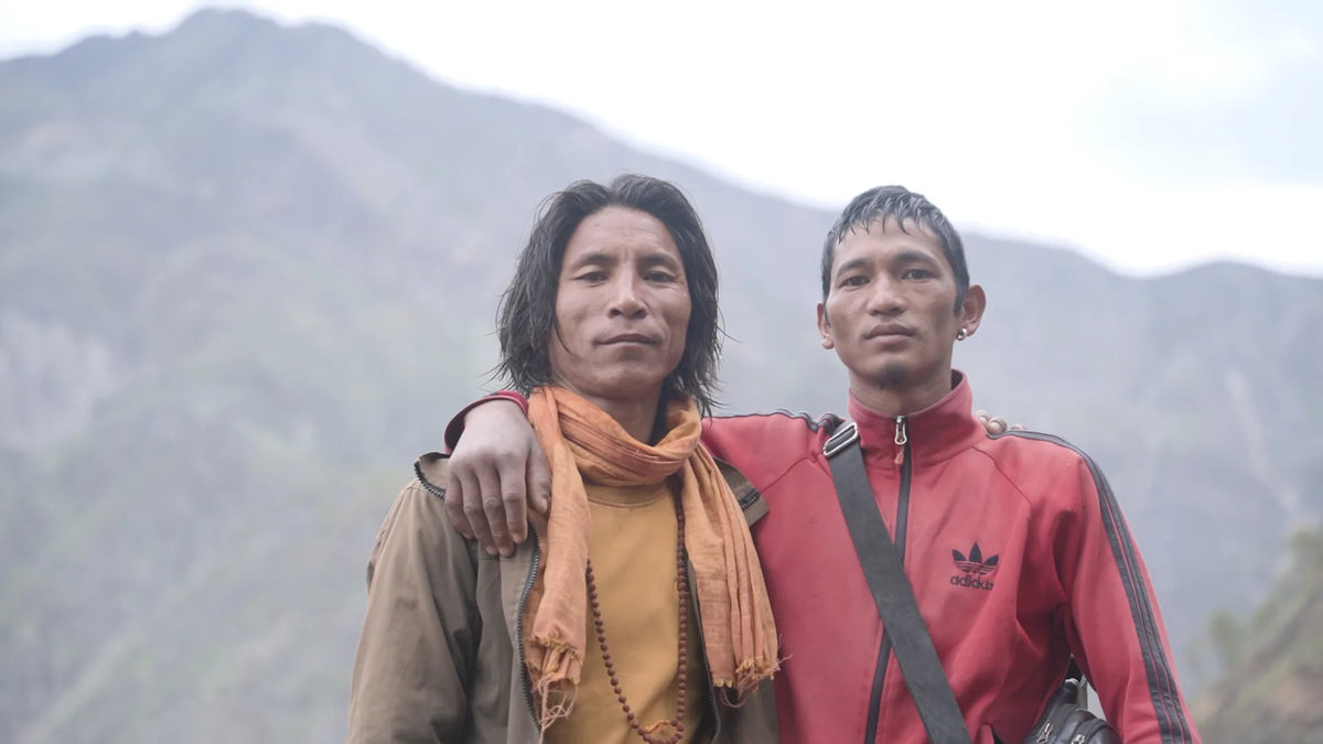 Two of the Nepali honey hunters behind Real Mad Honey, arm-in-arm on a mountain trail
