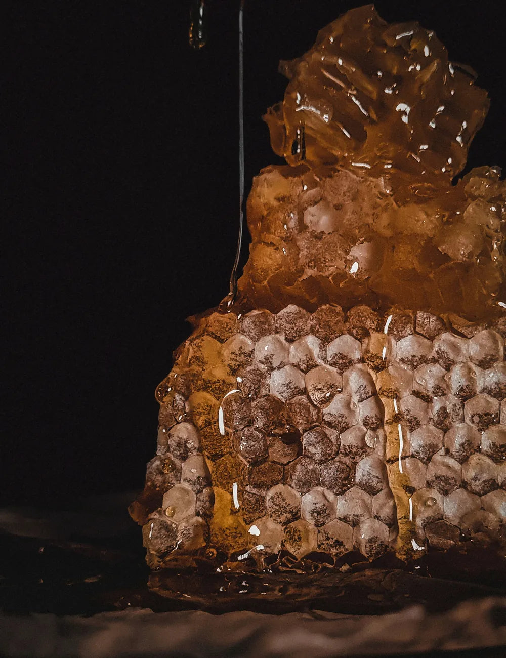 Raw honeycomb dripping with golden honey
