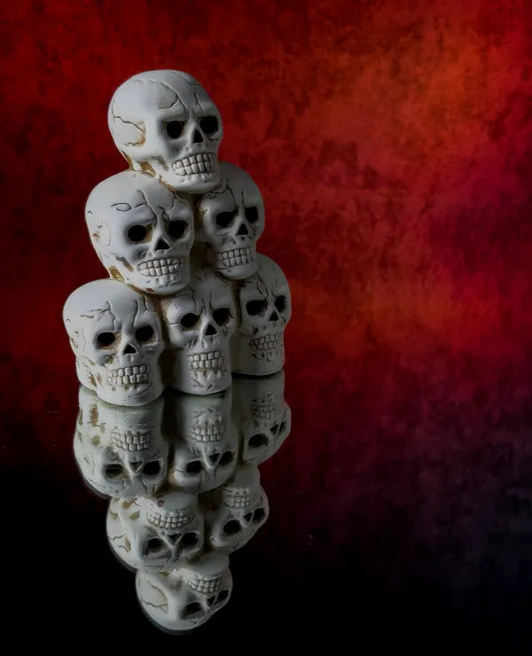 Tower of skulls against a red wall