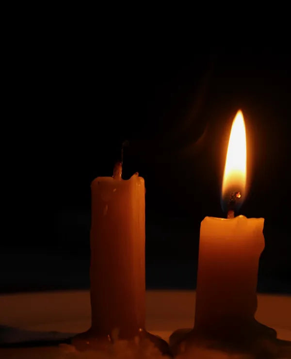 Two candles glowing in the dark